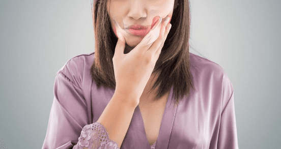 woman suffering from TMD pain